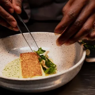 a person preparing food in a bowl