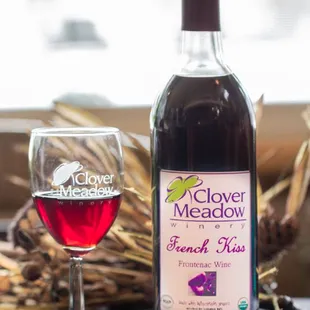 a bottle of french rose wine next to a glass of wine