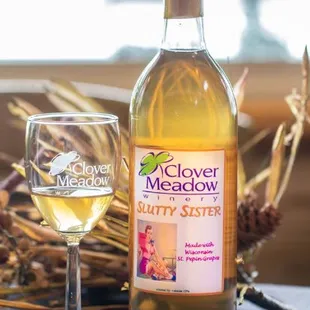 a glass of wine next to a bottle of wine