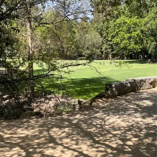 Picnic area and stone bridge over creek.