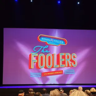 a large screen with the words the foolers on it