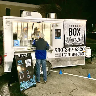 a man ordering food from a food truck