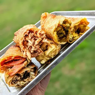 Pepperoni Pizza, BBQ Chicken, Shrimp Curry, Steak and Cheese, Mac N Cheese, and Vegetarian Curry Egg Rolls