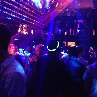 a crowd of people dancing at a nightclub