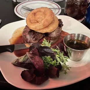 Filet with onion rings and salad garnish