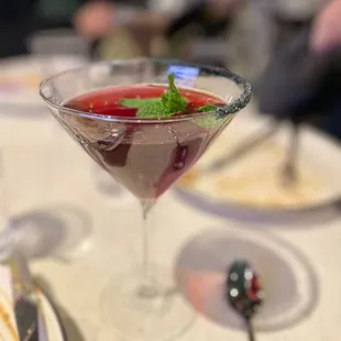 a cocktail in a martini glass on a table