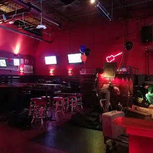 a bar with red walls and neon lights