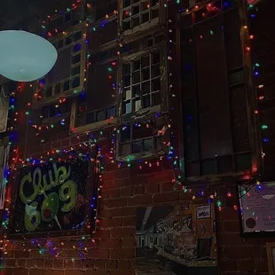 a brick wall covered in christmas lights