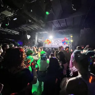 a large group of people dancing at a party