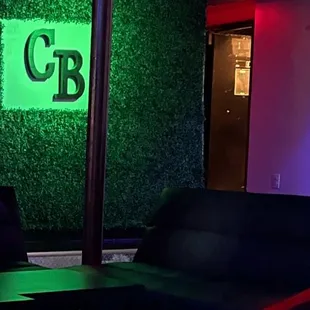 a couch and a table in front of a green wall