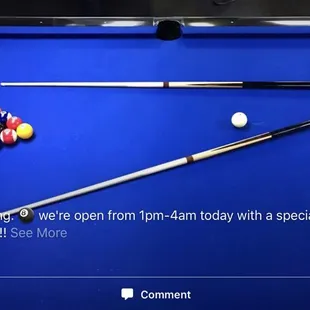 a pool table with cues and balls