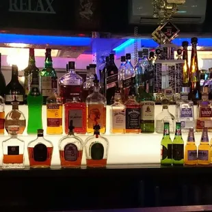 a variety of alcohol bottles on a bar