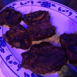 steaks on a plate with lettuce