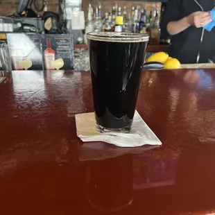 a pint of beer on a bar