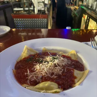 a plate of pasta with sauce and parmesan cheese