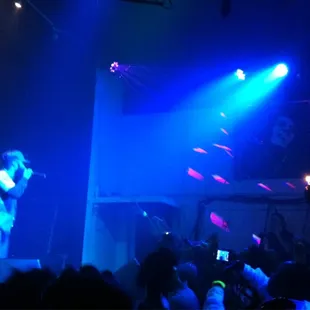 a woman singing on stage in front of a crowd