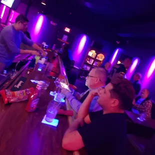 a group of people sitting at a bar