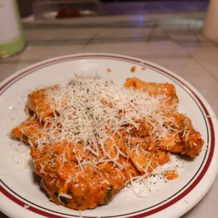 a plate of pasta with parmesan cheese