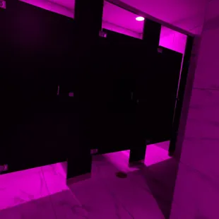 a bathroom with purple lighting