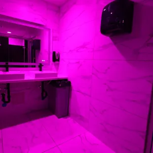 a bathroom with a pink light
