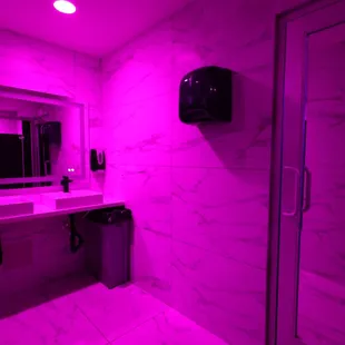 a bathroom with a purple light