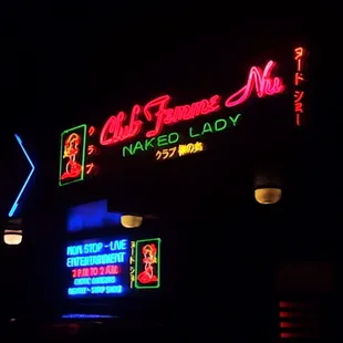 neon signs on the side of a building