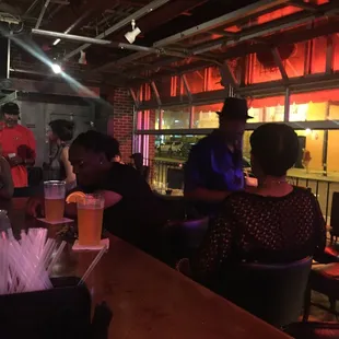 a group of people sitting at a bar