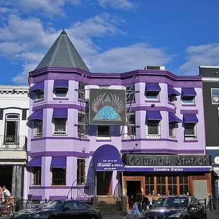 a purple building with a clock on it