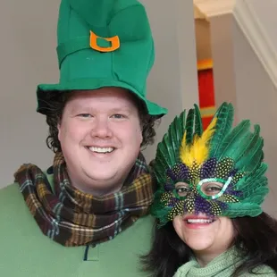 a man and a woman wearing green hats