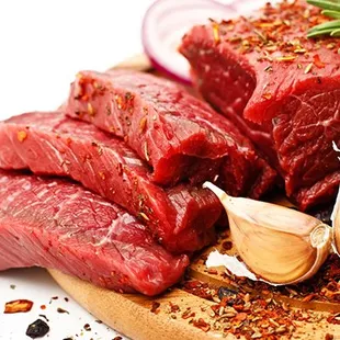 steaks and vegetables on a cutting board