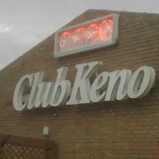 neon sign on brick building