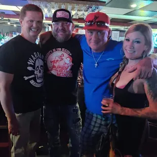 three men and a woman posing for a picture