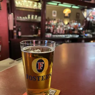 a pint of beer on a coaster