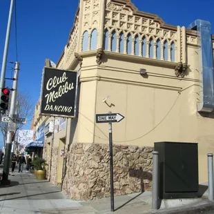 the corner of a street in front of a building