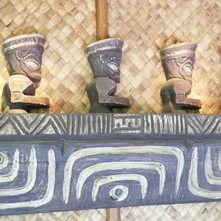 a row of carved heads on a wall