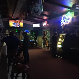 people playing video games in a bar