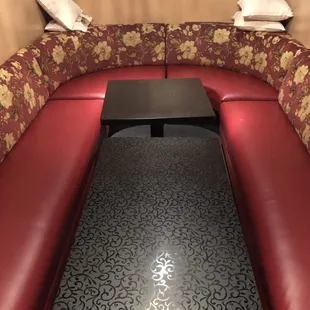 a red couch and a black table