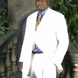 a man in a white suit and tie