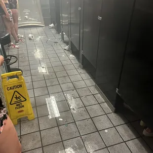 a group of people in a public restroom