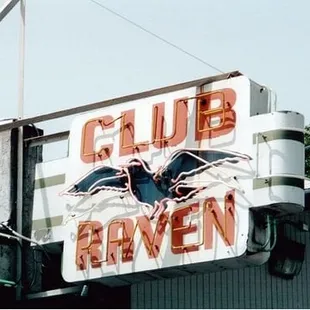 a neon sign on the side of a building