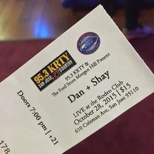 a hand holding a ticket