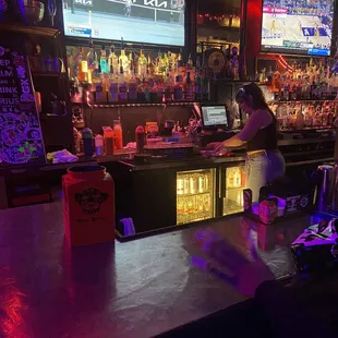 a woman at a bar with a laptop