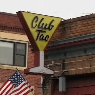 an american flag on a pole in front of a building