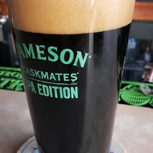 a glass of dark beer