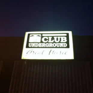 a neon sign on the side of a building