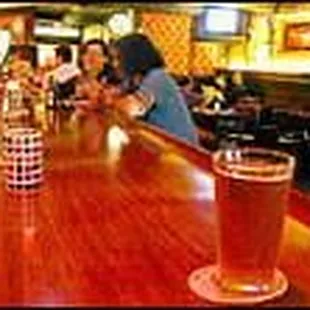 a pint of beer on a bar