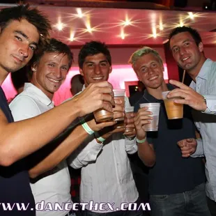 a group of young men drinking beer