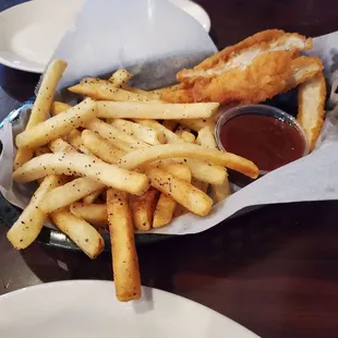 a basket of french fries and dipping sauce