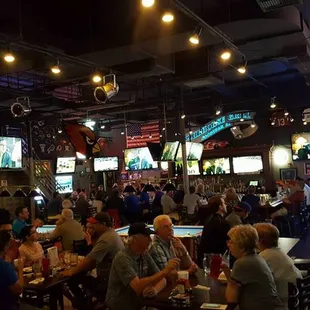 a large group of people eating and drinking