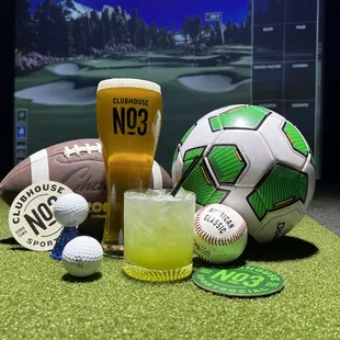 a glass of beer, a soccer ball, and golf balls